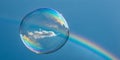 Floating bubble reflects sky and rainbow, capturing fleeting moments of wonder Royalty Free Stock Photo