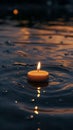 Floating candle on rippling water at dusk, warm glow. Peace and tranquility concept Royalty Free Stock Photo