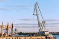 Floating cargo crane on barge near quay. Mooring in Riga. Royalty Free Stock Photo