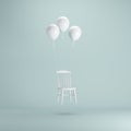 Floating chair with white balloons on pastel green background.
