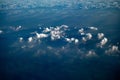 Floating clouds in the blue sky, view from airplane