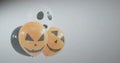 Floating cluster of four Halloween balloons showing jack-o\'-lantern and ghost faces in studio Royalty Free Stock Photo