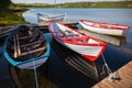 Floating Color Wooden Boats with Paddles in a Lake Royalty Free Stock Photo