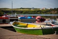 Floating Color Wooden Boats with Paddles in a Lake Royalty Free Stock Photo