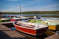 Floating Color Wooden Boats with Paddles in a Lake Royalty Free Stock Photo