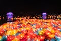 Floating colored lanterns and garlands on river at night on Vesak day for celebrating Buddha's birthday in Eastern culture, that