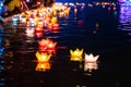 Floating colored lanterns and garlands on river at night on Vesak day for celebrating Buddha`s birthday in Eastern culture, that
