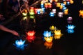 Floating colored lanterns and garlands on river at night on Vesak day for celebrating Buddha`s birthday in Eastern culture, that
