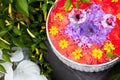 Floating colorful decorative flowers in a bowl of water