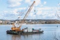 Floating construction barge with a crane on the Garonne river Royalty Free Stock Photo