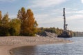 Floating crane moored to sandy river shore at autumn day Royalty Free Stock Photo