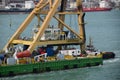 Floating crane pushed by a tug boat