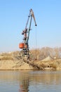 Floating crane on the river on the blue sky background