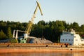 Floating crane in the river port on a summer day. The concept of export and import of goods Royalty Free Stock Photo