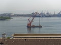 A Floating Crane sails slowly in to the Old Port of Rio de Janeiro at Porto Atlantico in Brazil.