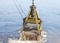 Floating crane scoops soil