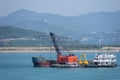 Floating crane working as a dredger near Chinese sea coast. Royalty Free Stock Photo