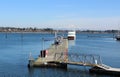 A floating dock with a ship on calm water in Drayton Harbor