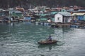 floating fish farm in ha long bay vietnam. Vietnamese poor, indigent woman walking on a fish farm. production of fish and