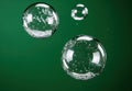 Floating glass bubbles on green background Royalty Free Stock Photo