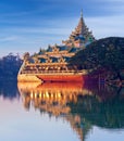 Floating golden Karaweik palace looks like royal barge at sunset on Kandawgyi Lake in Yangon Myanmar