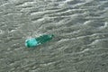 Floating green bottle