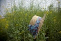 Floating hat in flower field Royalty Free Stock Photo