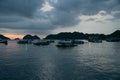 Floating Home boat in Cat Ba Island. Fisherman house boat moored in the bay in front of the city at sunset. Royalty Free Stock Photo