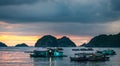 Floating Home boat in Cat Ba Island. Fisherman house boat moored in the bay in front of the city at sunset. Royalty Free Stock Photo