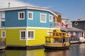 Floating Home Village Colorful Houseboats and water taxi. Fisherman`s Wharf Reflection Inner Harbor, Victoria BC