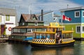 Floating Home Village Colorful Houseboats and water taxi. Fisherman`s Wharf Reflection Inner Harbor, Victoria BC Royalty Free Stock Photo
