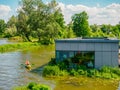 Floating house or house on water in a reeds on a river in a city, contemporary living