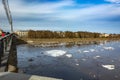 Floating of ice in the spring on the river in the city.