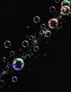Floating Iridescent Bubbles on Black Background Illuminated with Spectral Highlights Royalty Free Stock Photo