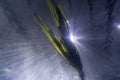 Floating kelp piece in a water tunnel below a pool. Light rays and reflections shineFloating kelp piece in a water tunnel below a