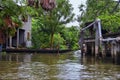 Floating Market by Bangkok Thailand, Damnoen Saduak. Views from tour boat of local sales shops, canals and vegetation landscape. Royalty Free Stock Photo