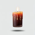 A floating in mid air candle with a visible flame, on a solid white background Royalty Free Stock Photo