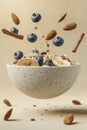 Floating oatmeal with blueberries, cinnamon, almonds and honey in a bowl on a beige background. Healthy breakfast Royalty Free Stock Photo