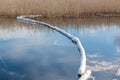 Floating oil containment boom at a calm lake after an oil spill Royalty Free Stock Photo