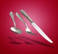 Floating Old Silverware Set with shadows on red gradient Royalty Free Stock Photo