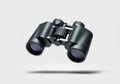 A floating pair of binoculars with a textured grip, perfectly horizontal, on a solid white background Royalty Free Stock Photo
