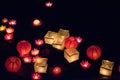Floating paper lanterns on the water at night