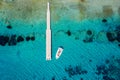 A floating pier with a rib boat over the turquoise, clear sea