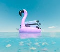 Floating Pink Flamingo Inflatable with Suitcase in Ocean Royalty Free Stock Photo