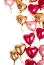 Floating Pink, Red and Gold Real Metallic Balloons Hearts on a White background, for Love Themed Events and