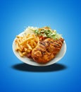 Floating of Piri Piri Chicken on white plate on blue gradient