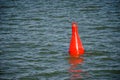 Floating red buoy on blue water Royalty Free Stock Photo