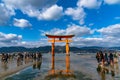 Floating red giant Grand O-Torii gate stands in Miyajima island bay beach