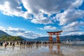 Floating red giant Grand O-Torii gate stands in Miyajima island bay beach