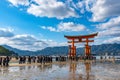 Floating red giant Grand O-Torii gate stands in Miyajima island bay beach